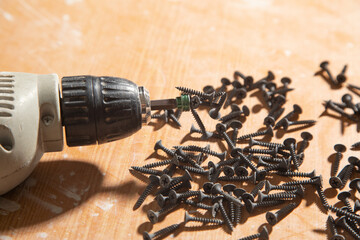 Poster - Drill with screws on the table.