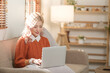 © Treerat - Portrait of Asian young woman working using smartphone computer or tablet working online at home office , freelance business online concept.