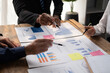 © Parichat - Businessmen are brainstorming for business investment strategies, charts and documents for business people.