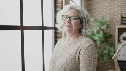 Poster - Middle age woman with grey hair business worker smiling confident at office