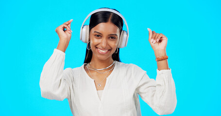 Poster - Face, music and Indian woman with headphones, streaming and happiness against blue studio background. Portrait, female and lady with headset, listening to song and dancing with success and celebrate