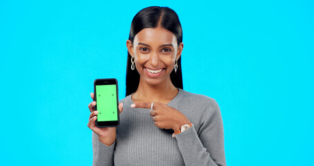 Sticker - Woman, pointing and phone green screen mockup with a smile and hand for advertising website space. Face of indian female model with smartphone for branding app, logo or ux while happy and excited