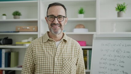 Sticker - Middle age man teacher smiling confident standing at classroom