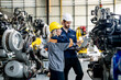 © FotoArtist - Industry 4.0: Engineer Monitoring Robotics Welding in Intelligent Factory. Digital manufacturing operation.