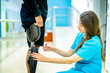 © FotoArtist - Female physiotherapist helping young man with prosthetic leg..Nurse helping man walk with prosthetic leg..Young disabled man using orthopedic equipment to walk