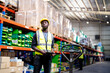 © FotoArtist - Warehouse workers checking the inventory. Products on inventory shelves storage. .Worker Doing Inventory in Warehouse. Dispatcher in uniform making inventory in storehouse.