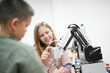 © FotoArtist - Children learning AI technology Robot with artificial intelligence system on its about the artificial intelligence during science lesson.