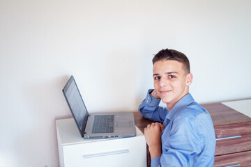 young man is working on a laptop