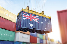 Cargo Shipping Container With Australian Flag In A Port Harbor. Production, Delivery, Shipping And Freight Transportation Of Australia Concept.