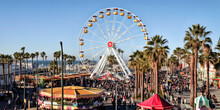 The Sun Sets Over A Ferris Wheel In Santa Monica, Bathing The Amusement Park In A Golden Light. - Generative Ai.