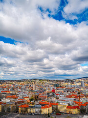 Wall Mural - Bratislava city skyline, buildings, and traditional houses with red roof tiles on cloudy day in Slovakia, aerial view