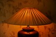 © Omega - Pleating lampshade with warm light in dark room, closeup.