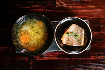 fish soup on a wooden table. restaurant serving dishes