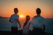 Naxos, Grece - July 20, 2020 - Mother and children having amazing time watching amazing sunset over Naxos Island