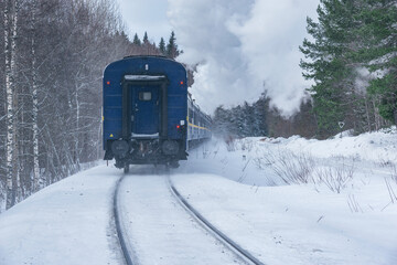 Wall Mural - Retro steam train moves at winter morning time.