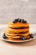 © Michael Marquand - Stack of pancakes with blueberries and maple syrup