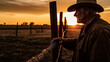 © Caseyjadew - Silhouette image of farmer leaning against fence post thoughtfully at sunset. Time out after a long day's work on the land.