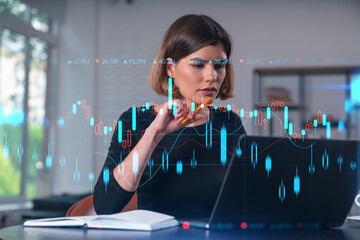 Wall Mural - Pensive attractive beautiful businesswoman in formal wear working on laptop at office workplace in background. Forex graph and charts hologram icons. Concept of market trading and research.