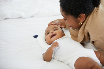 Wall Mural - African adorable baby with mother on bedroom