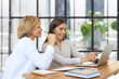 © ty - Beautiful businesswoman work together sitting on the table in office.