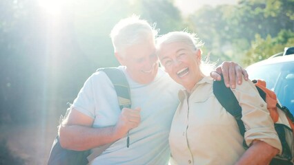 Wall Mural - Portrait of smiling senior couple with backpacks going for hike in countryside standing by car together - shot in slow motion