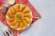 Arabian pancake Qatayef with qishta cream and pistachio . Traditional sweets with ramadan decor