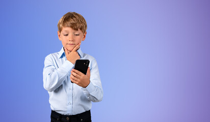 Kid using smartphone with hand on chin, copy space gradient background