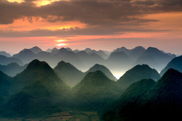 The magical scene of the mountains resemble the successive message they are covered with layers of lush green vegetation at dawn in Bac Son district Lang Son Province, Vietnam