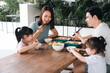 © Timeimage - Image of Asian family eating lunch together
