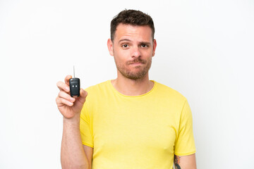 Wall Mural - Young man holding car keys isolated on white background with sad expression