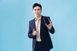 © Timeimage - Photo of young Asian businessman on background