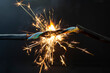 flame smoke and sparks on an electrical cable, fire hazard concept