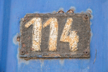 Wall Mural - Old retro weathered cast iron plate with number 114