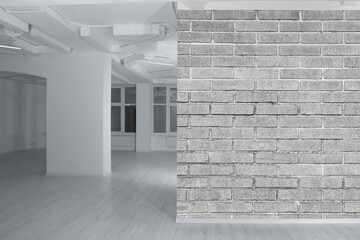 Poster - Spacious room with brick wall and wooden floor