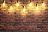 Fototapeta Kawa jest smaczna - Many pendant lamps against red brick wall