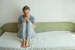 © evafesenuk - Melancholy senior woman sitting on sofa