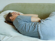 © evafesenuk - back view senior woman lying on sofa with her back turned, suffering from depression