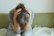 © evafesenuk - Upset senior woman sits on sofa, suffers from depression, loneliness.