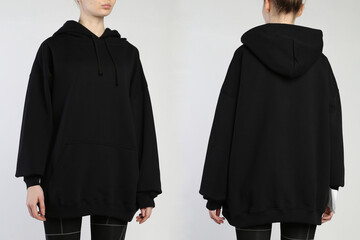 A woman wears a black hoodie