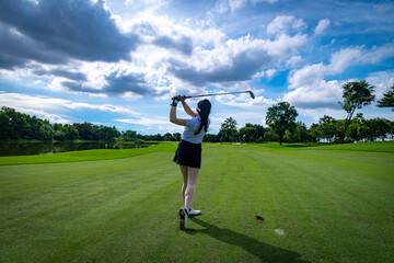 Wall Mural - Professional woman golfer teeing golf in golf tournament competition at golf course for winner	