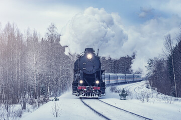 Wall Mural - Retro steam train moves at winter morning.