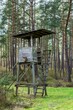 A wooden observation or hunting tower in the middle of a European forest 