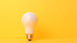 © adel - Glowing light bulb isolated on a bright yellow background ai generative
