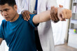 © ArLawKa - Male chiropractor, physiotherapist or orthopedist examining a patient suffering from scoliosis or pain in the back and limbs, treatment concept. Patient in rehabilitation physiotherapy hospital