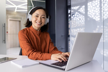 young successful female programmer at workplace inside office working with laptop, coding software, 