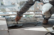 © HC FOTOSTUDIO - Mason placing cement on a slab with a mason's trowel. I work in a construction.