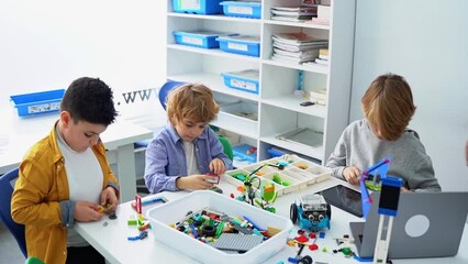 Wall Mural - robotics programming class. children construct and code robot. stem education using constructor bloc