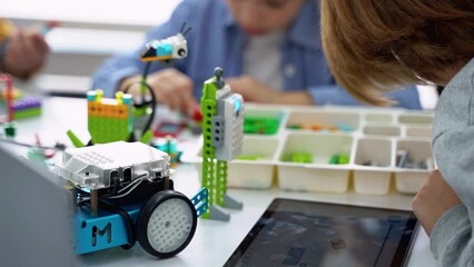 Wall Mural - robotics programming class. children construct and code robot. stem education using constructor bloc