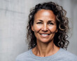 © OPPERMAN - Smiling 40 year old woman standing in front of a grey wall. Generative AI.