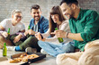© Goran - Group of friends having fun while sitting on the floor at home